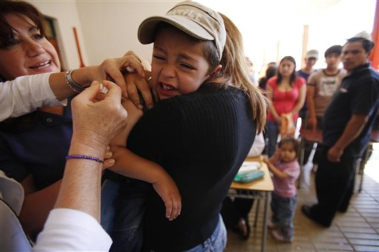 A boy is vaccinated in Constitucion, Chile, on Friday.